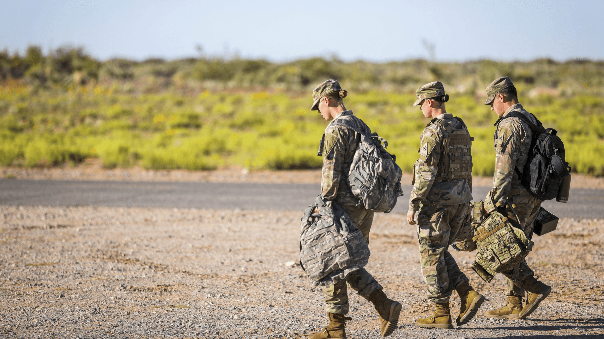 U.S. service members moving across an operations zone.